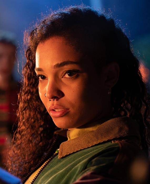 Talitha Wing wearing a nose ring and green and brown jacket