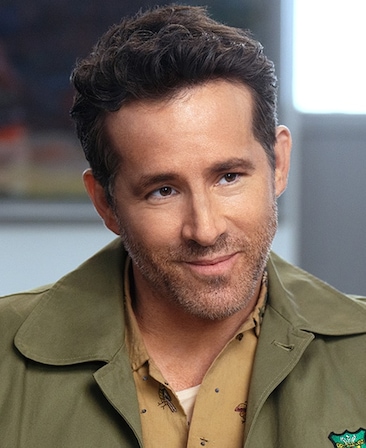 Ryan Reynolds headshot wearing a green jacket with a Wrexham logo a tan button up underneath from FX's Necaxa.