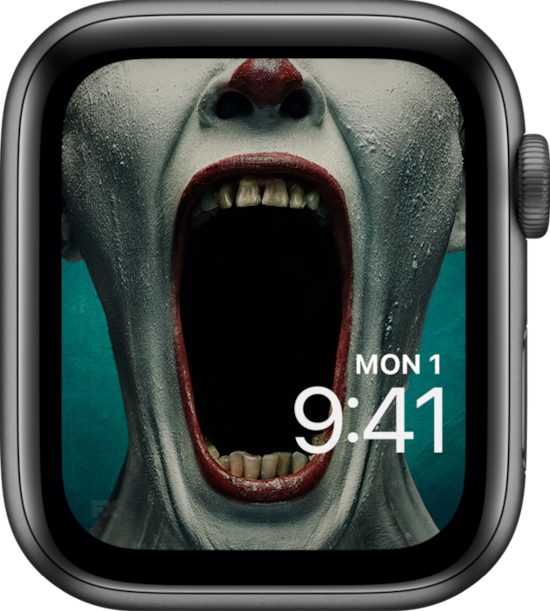 Apple Watch lock screen of clown in white makeup and red lipstick opening jaw wide in FX's AHS Freak Show