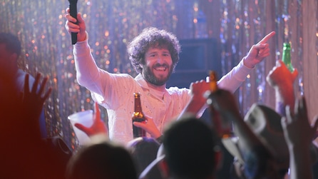 Dave throwing his hands in the air with a crowd of people in front of him