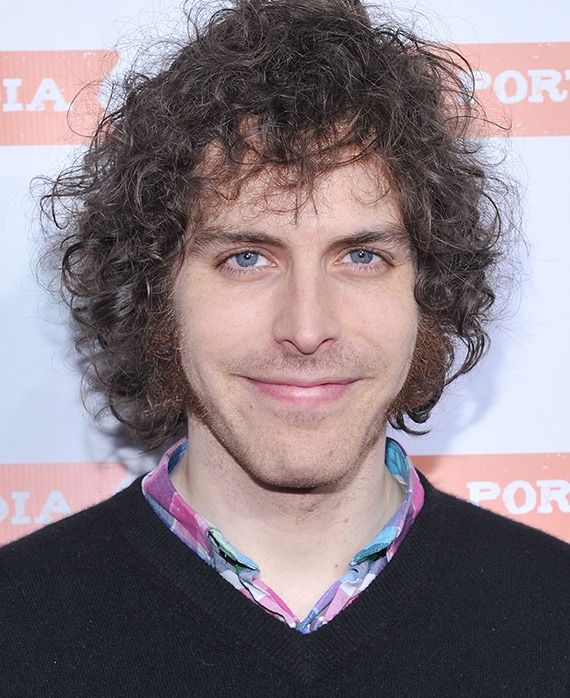 Headshot of executive producer / director Jonathan Krisel wearing a black sweater with a colorful shirt underneath.