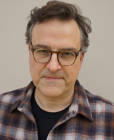 Chris Provenzano headshot wearing a black shirt with a red plaid button up.