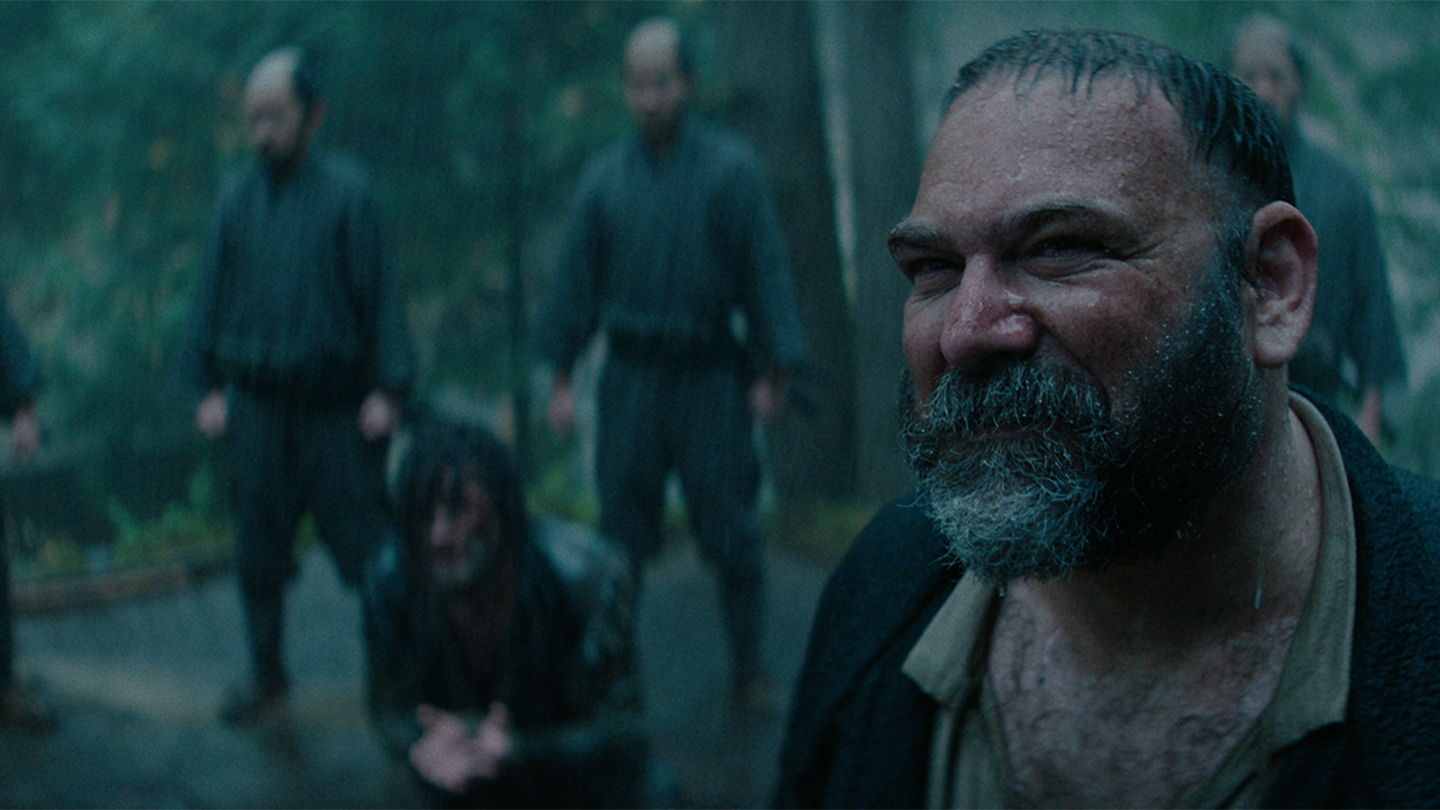 Blackthorne is held captive while a Portuguese priest translates for him in the rain