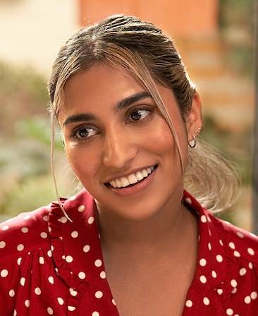 Deepica Stephen headshot wearing a red and white polka dot top.