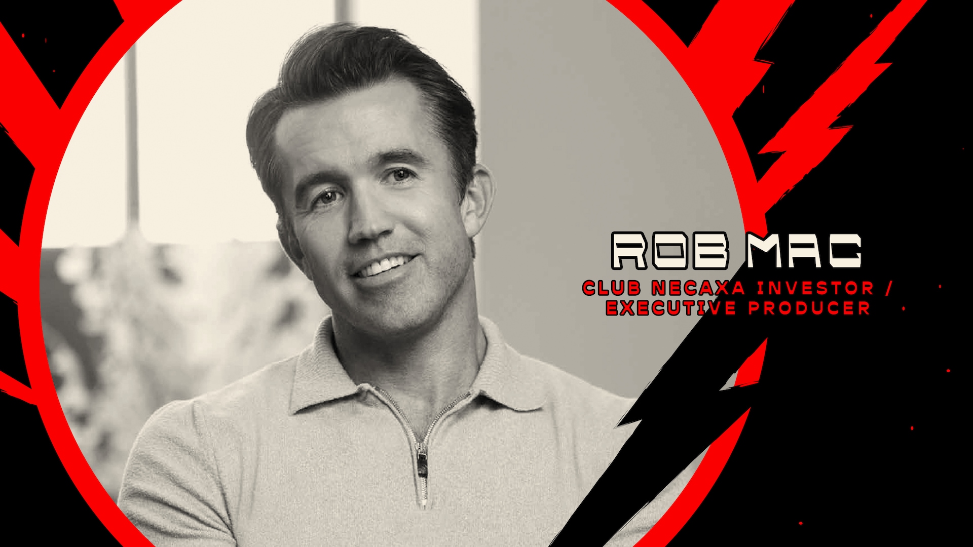 Rob Mac wearing a zip up sweater with a black and red electric background circled around him.