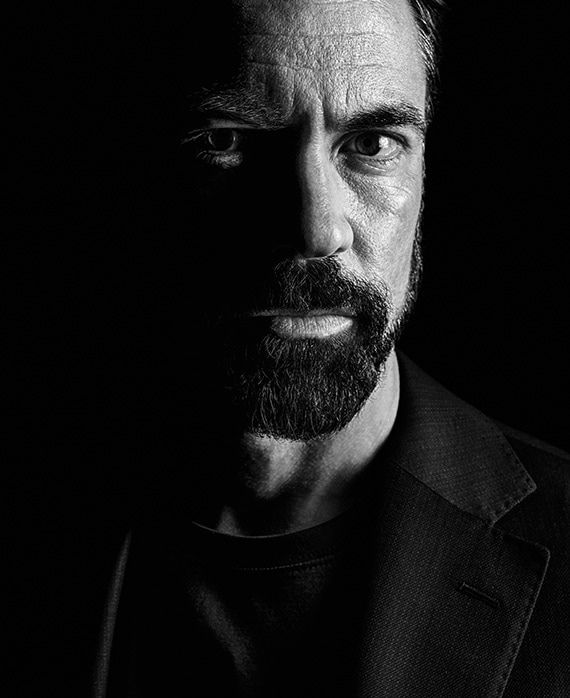 Danny Pino Headshot wearing a black shirt and fading into the background