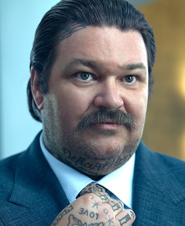 Matty Matheson headshot wearing a blue suit and tie.