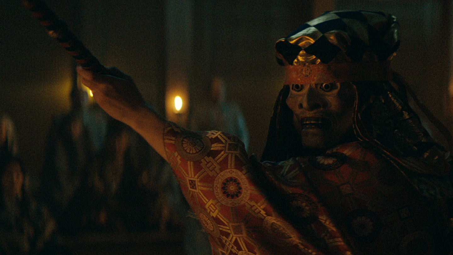 Close up of Noh masked actor performing play