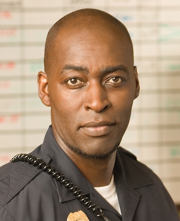 Michael Jace headshot wearing a police uniform and badge