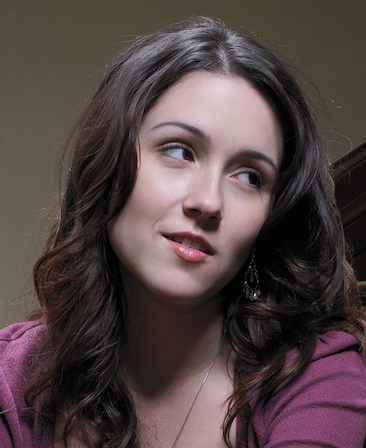 Shannon Woodward headshot wearing a maroon top and necklace