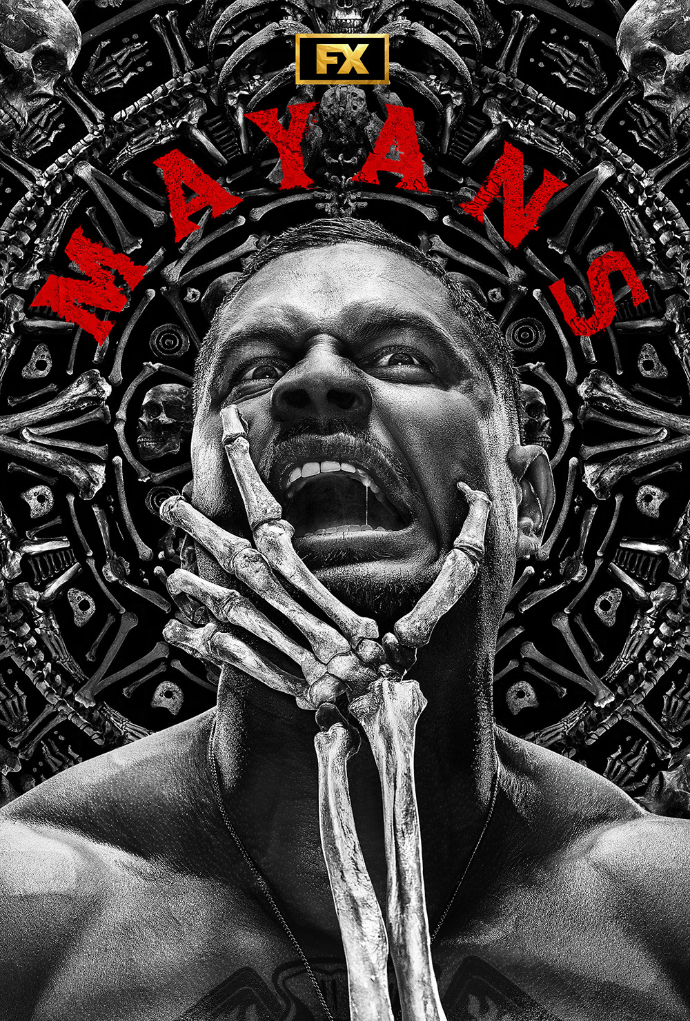JD Pardo shirtless with mouth open and a skeleton hand grabbing his face for FX's Mayans