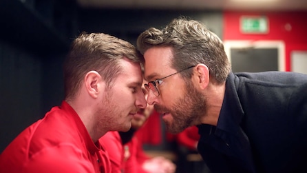 Ryan Reynolds pressing his forehead against a soccer player's head
