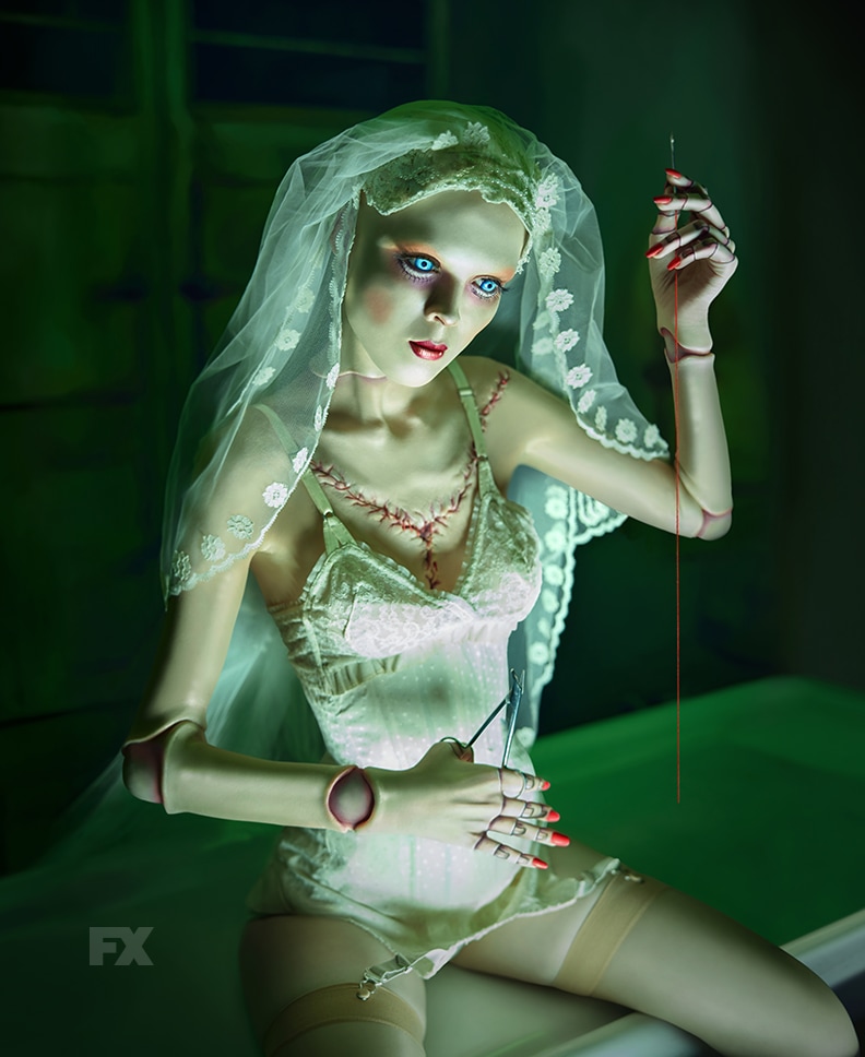Doll wearing white undergarments wearing veil and holding needle from FX's American Horror Stories