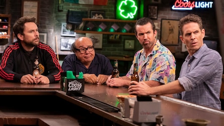 Charlie, Frank, Mac, and Dennis looking with eyebrows raised to their left at bar top in FX's It's Always Sunny