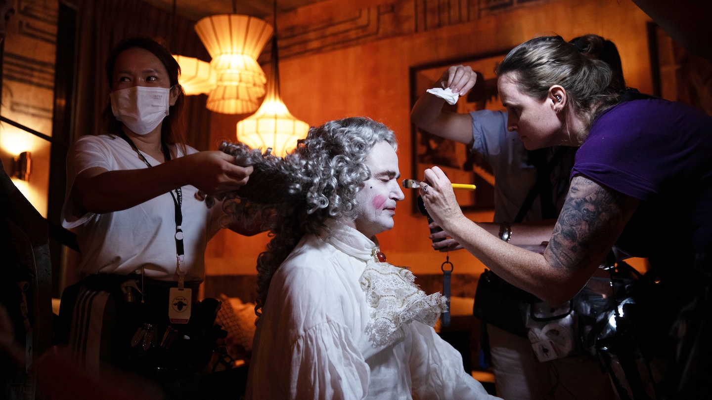 Person in Victorian clothing getting their makeup done
