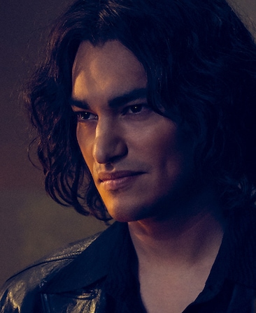 Zach Villa headshot with shoulder length hair and black leather jacket from American Horror Story 1984
