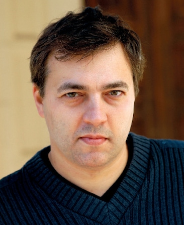 Dmitry Lipkin headshot wearing a navy knit sweater