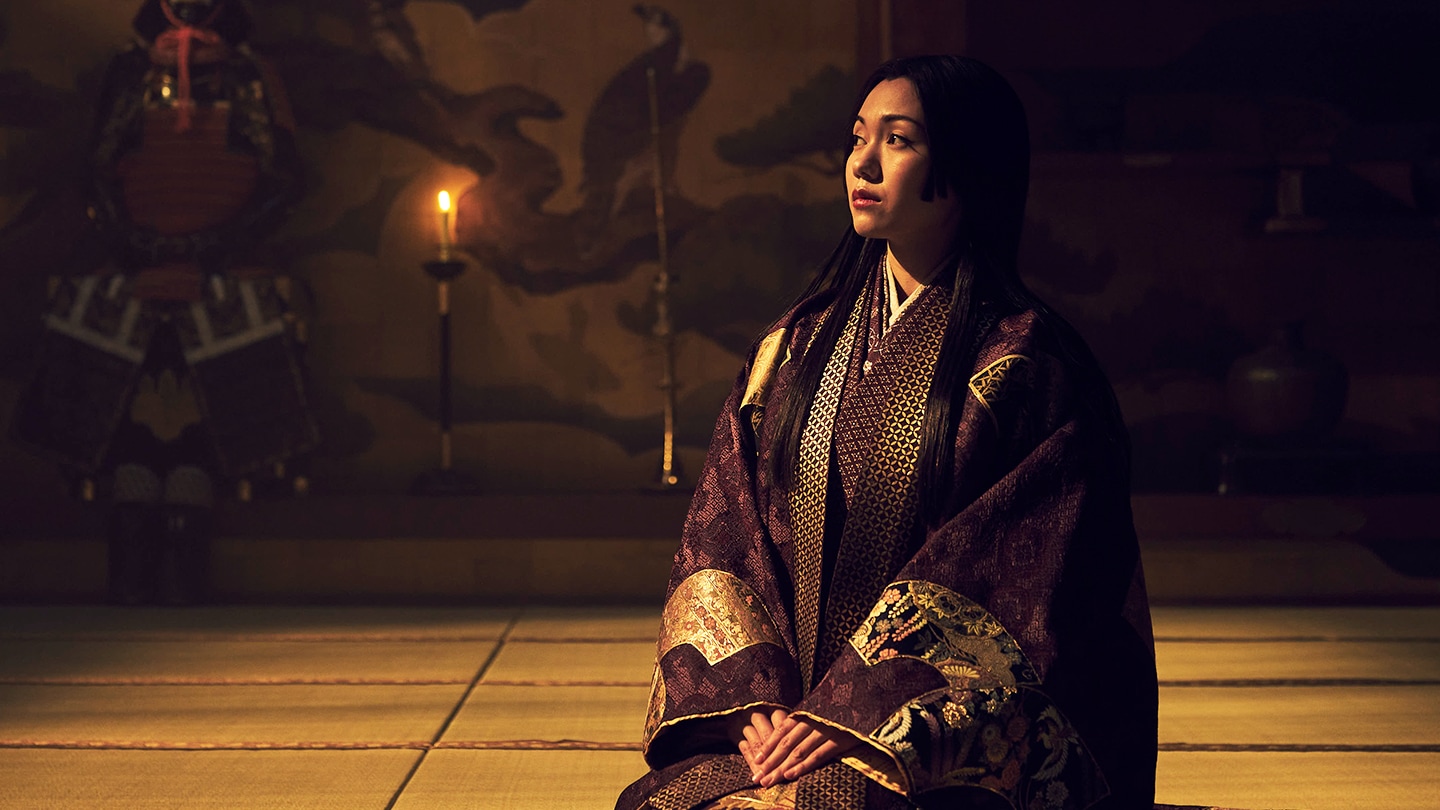 Side profile of Ochiba dressed in a dark purple uchikake on the set of Shogun