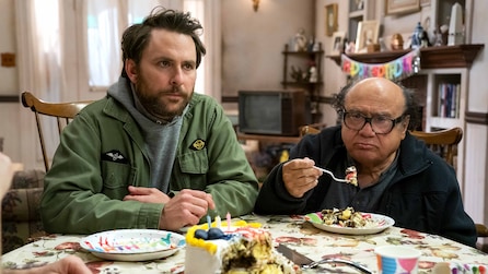 Charlie and Frank sitting and eating at a dining table together.