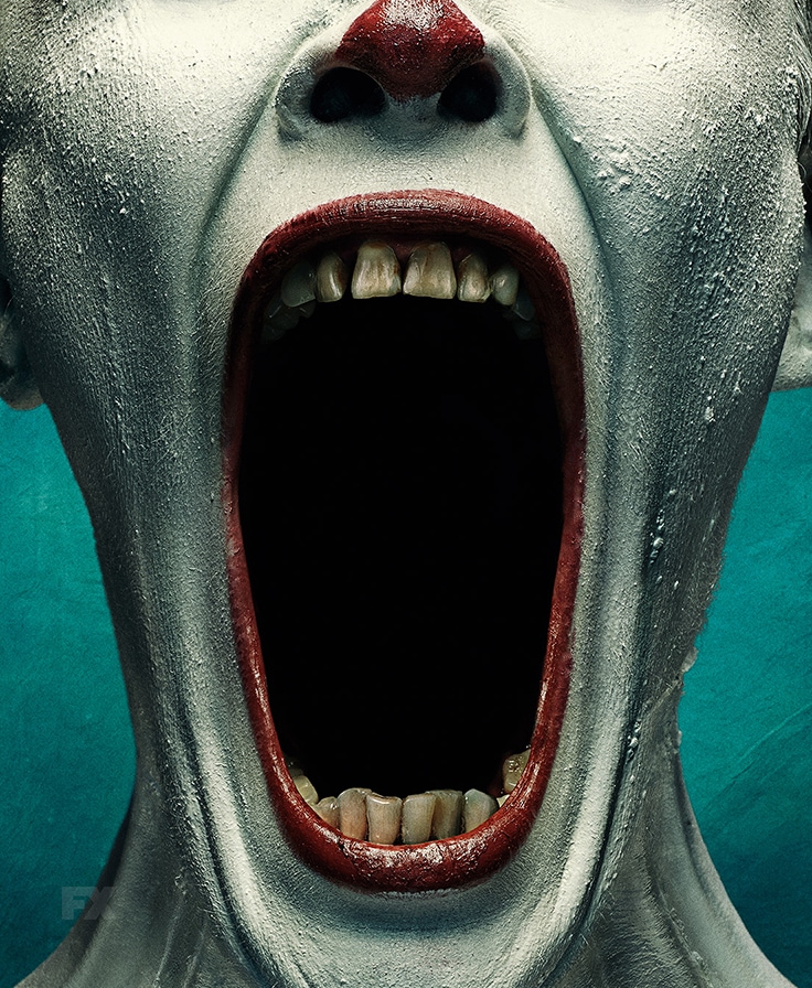 Clown in white makeup and red lipstick opening jaw wide in FX's AHS Freak Show