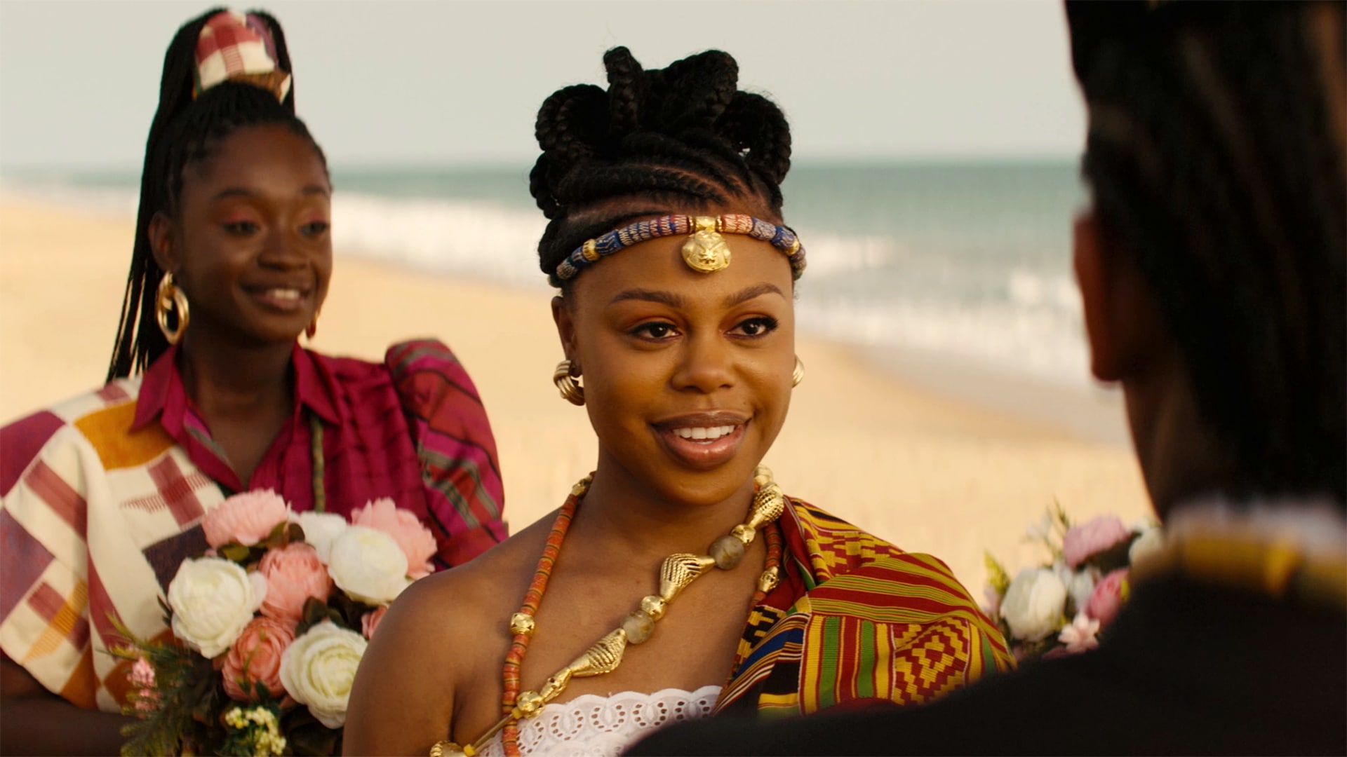 Two women standing on the beach smiling