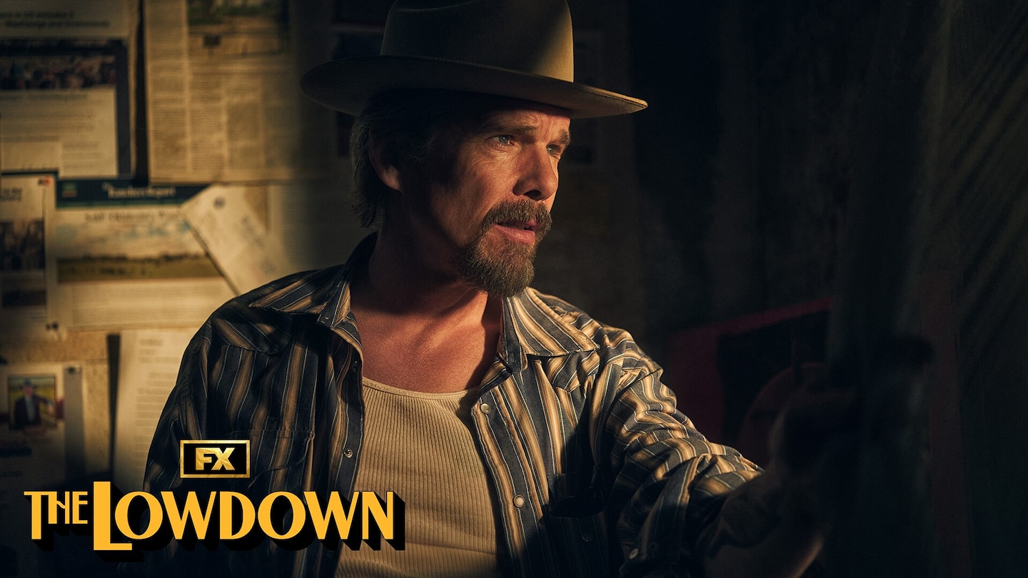 Ethan Hawke wearing a striped shirt and brown hat for FX's The Lowdown.