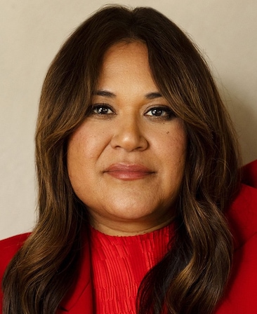 Headshot of executive producer of FX's Necaxa, Rachel Mendez, wearing a red suite and shirt.