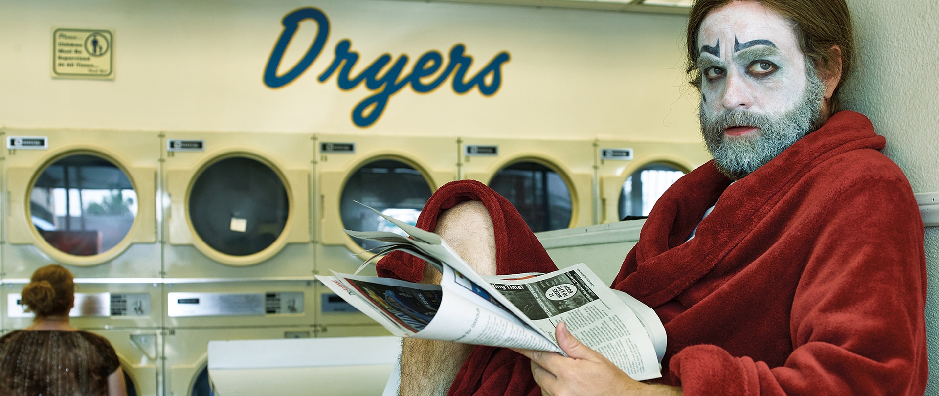 Zach Galafianakis as Chip Baskets for FX's Baskets in a red robe and clown makeup, in a laundromat.