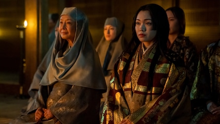 Lady Ochiba and Daiyoin kneeling next to each other in a candlelit room
