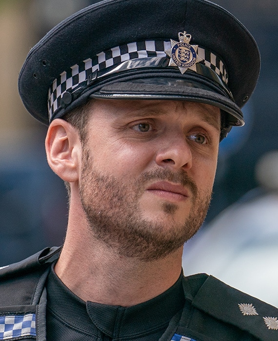 Wim Snape headshot wearing a United Kingdom Police uniform and hat