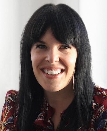Headshot of Alexis Martin Woodall, Executive Producer of FX's Grotesquerie, wearing a red printed blouse.