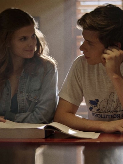 Kate Mara and Nick Robinson sitting next to each other with a book open on the table