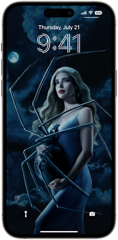 AHS: Delicate lock screen of a woman with white hair, standing with a spider on her stomach, in front of a dark and cloudy ba