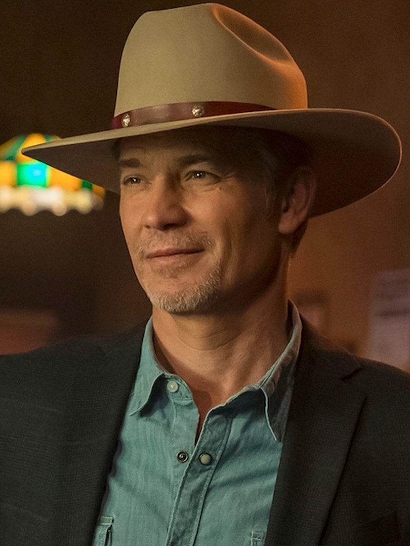 Raylan Givens wearing a cowboy hat, denim shirt and suit jacket