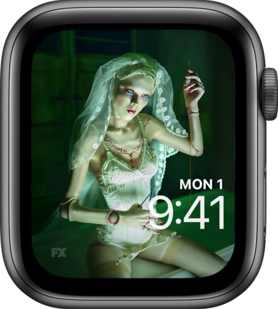 Apple Watch lock screen of doll in white undergarments wearing veil and holding needle from FX's American Horror Stories