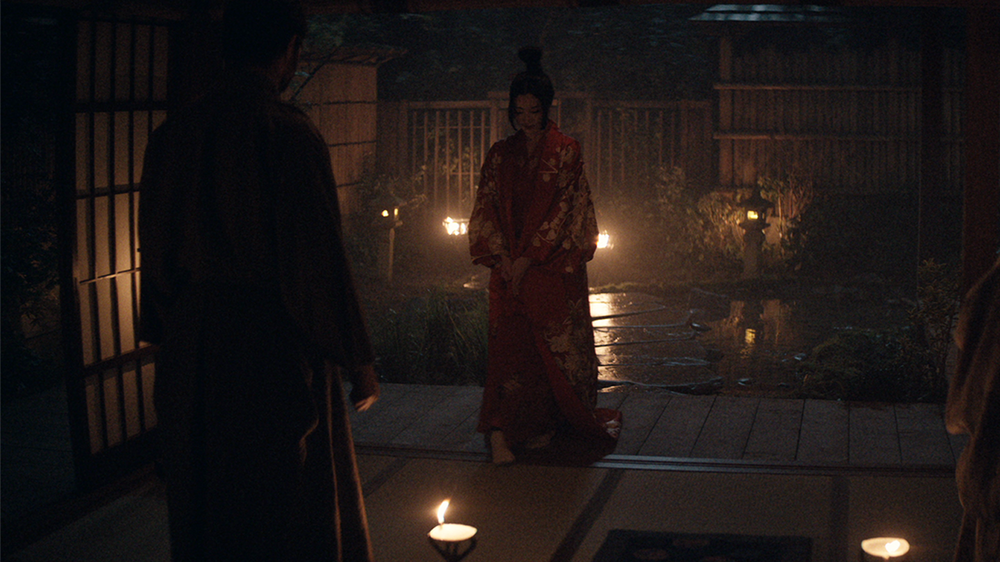 Kiku dressed in red gathers with Blackthorne and Mariko at night