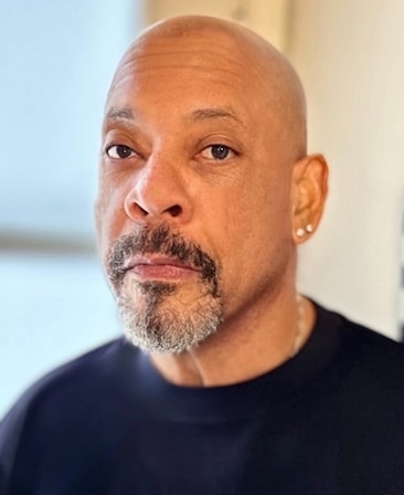 Carl Franklin headshot in a black t shirt.