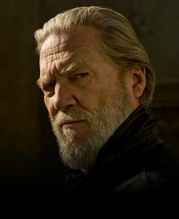 Jeff Bridges headshot wearing black jacket in the outdoors