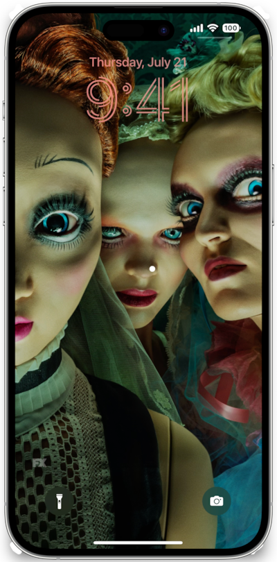 iPhone lock screen of dolls with wide eyes and colorful garments and makeup from FX's American Horror Stories