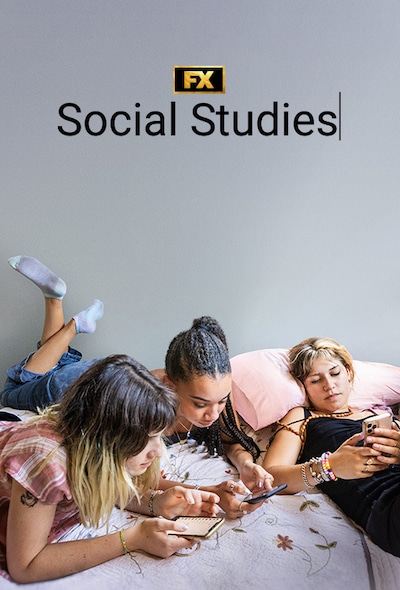 A group of three teenage girls look at their cell phones while lying on a bed.