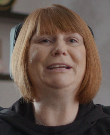 Kerry Evans headshot wearing a black hoodie 