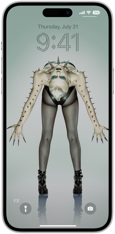 iPhone lock screen of person in black heels and fishnet tights bending backwards with arms out with spikes from FX'S AHS NYC
