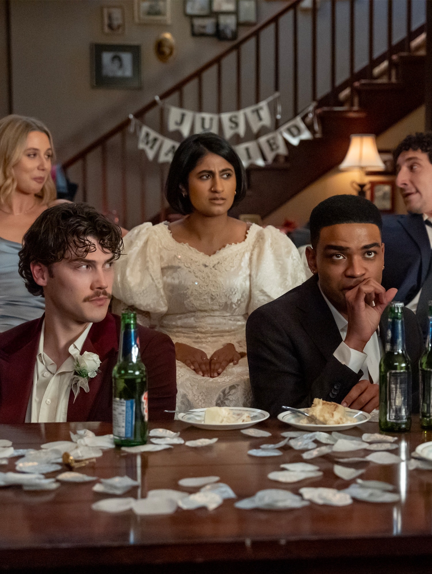 The cast of FX's Adults sitting on their couch in the living room.