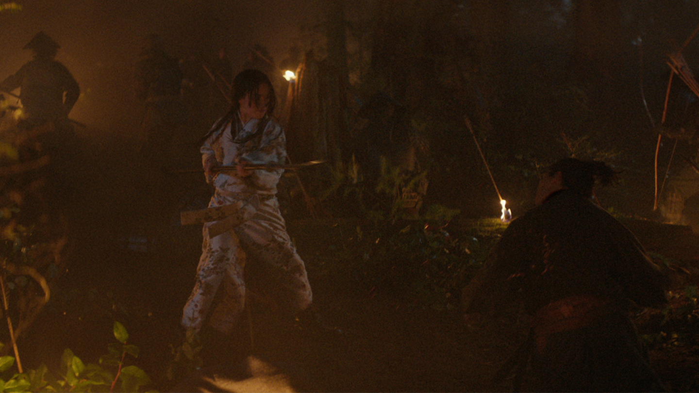 Mariko armed with a spear in the midst of battle