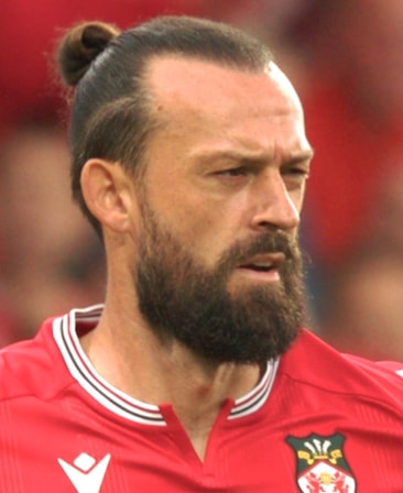 Steven Fletcher headshot, wearing his WAFC jersey and his hair pulled back in a neat bun.