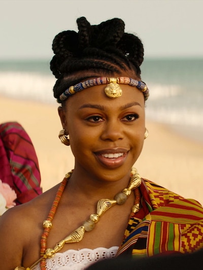 Woman standing on the beach smiling