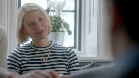 Claire Danes as Rachel in black and white striped shirt smiling at obscured man in white room in FX's Fleishman Is In Trouble