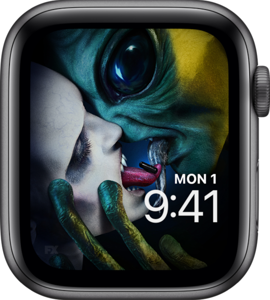 Apple Watch lock screen of alien and fanged monster swapping black pill with tongues from FX's AHS Double Feature