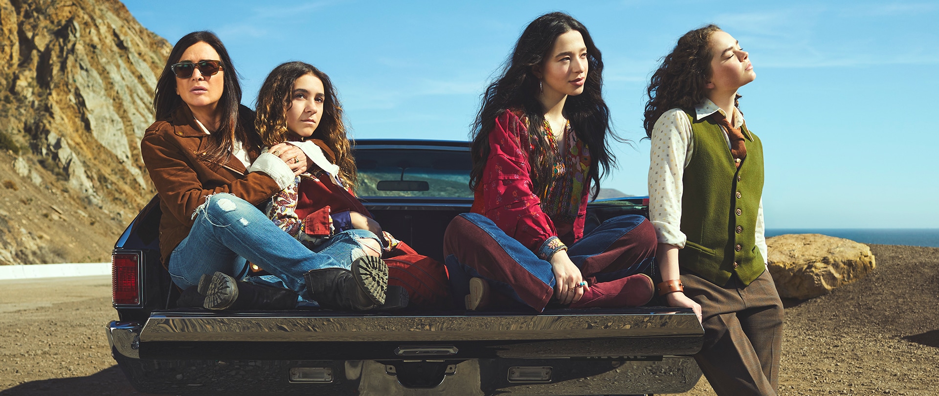 Cast of FX's Better Things at the beach sitting in the bed of a pick up truck.