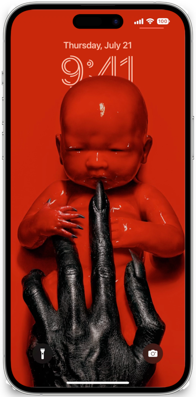 iPhone lock screen of red baby with black claws cradled by black hands American Horror Story 8 Apocalypse
